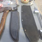 Hammer and knife sheaths on a table.