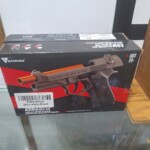 Toy gun in a black and red box.