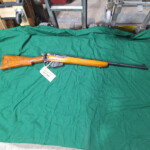 Bolt-action rifle with wooden stock
