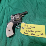 Vintage white-grip starter pistol with tag