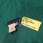 Compact .22 caliber pistol with yellow tag