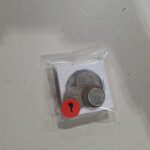 Small bag of coins with red question sticker