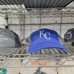 Blue KC baseball cap on metal shelf