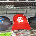 Red KC baseball cap on metal shelf