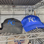 Two KC baseball caps on metal shelf
