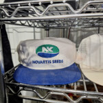 White Novartis Seeds baseball cap with blue brim