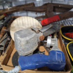 Assorted rusty hand tools in cardboard box