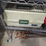 Beige Rebel toolbox with rusted clamps below