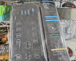 Packaged black power strip on wire shelf
