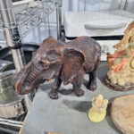 Carved wooden elephant figurine on shelf