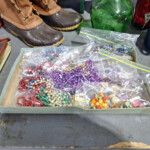 Assorted beads and necklaces in plastic bags
