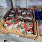 Box of decorative ribbon spools on shelf