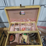 Open pink jewelry box with assorted jewelry