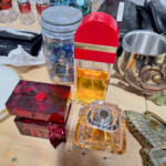Perfume bottles and trinkets on wooden table