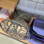 ornate cast-iron decorative wheel on shelf