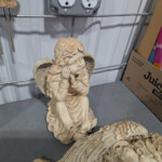 Small angel cherub statue sitting on shelf