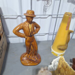 Brown ceramic figurine of man in hat