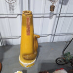 Yellow ceramic cone-shaped pitcher on table