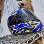 Blue motorcycle helmet on metal shelf