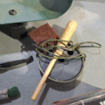 Drum practice pad with wooden mallet and cord