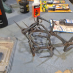 Rusty metal animal trap on workbench