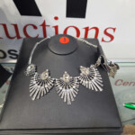 Silver rhinestone fan necklace on black stand