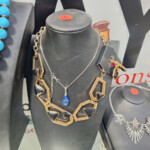 Geometric gold necklace with black and blue pendant