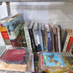 Assorted books and boxed children's cards on shelf