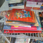 Stack of children's Christmas books on metal shelf