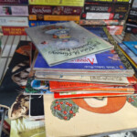 Stack of colorful children's books on shelf