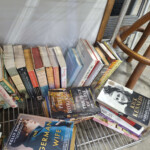 Assorted paperback books on metal display rack