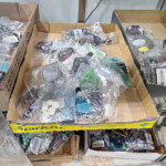 Assorted costume jewelry in cardboard trays