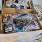 Box of assorted packaged jewelry and accessories