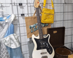 Vintage white electric guitar with yellow bag