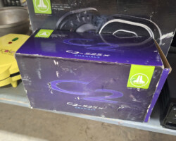 Purple JL Audio speaker boxes on shelf