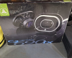 Boxed car speakers on metal shelf