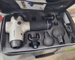 Percussion massage gun with attachments in case