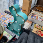 Teal guitar-shaped marquee light on table