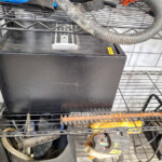 Black lockbox and tools on metal shelf
