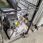 Small portable air compressor on metal shelf