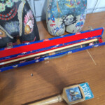 Pool cue case, bottle, painted mannequin legs