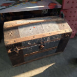 Antique wooden steamer trunk with metal accents