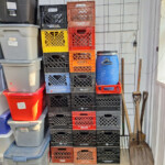 Stacked milk crates, storage bins, and shovels