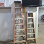 Two ladders leaning against wall